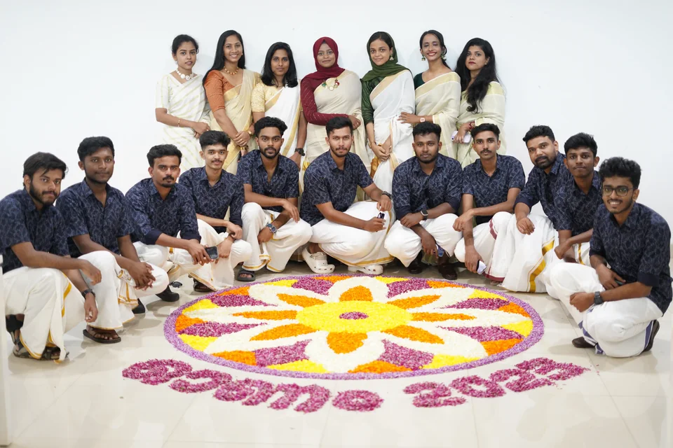 The Trogon team posing beside their Onam floral pookalam